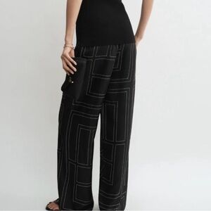 Woman’s TOTEME
Monogram-Embroidered Silk Pajama Pants